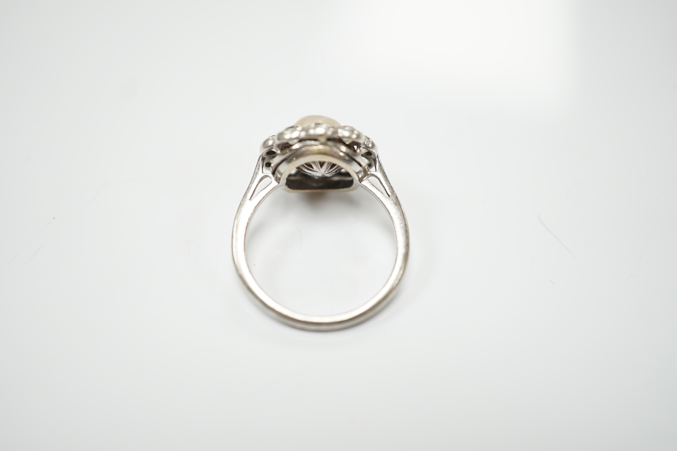 A white metal (stamped Pall) cultured pearl and diamond set circular cluster ring, size L, gross weight 3.3 grams.